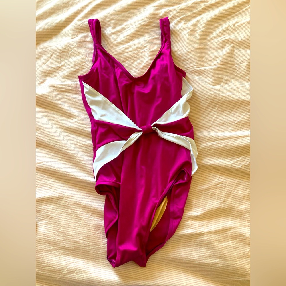 One piece swimsuit. Fuchsia and white.  V neck, high cut sides.